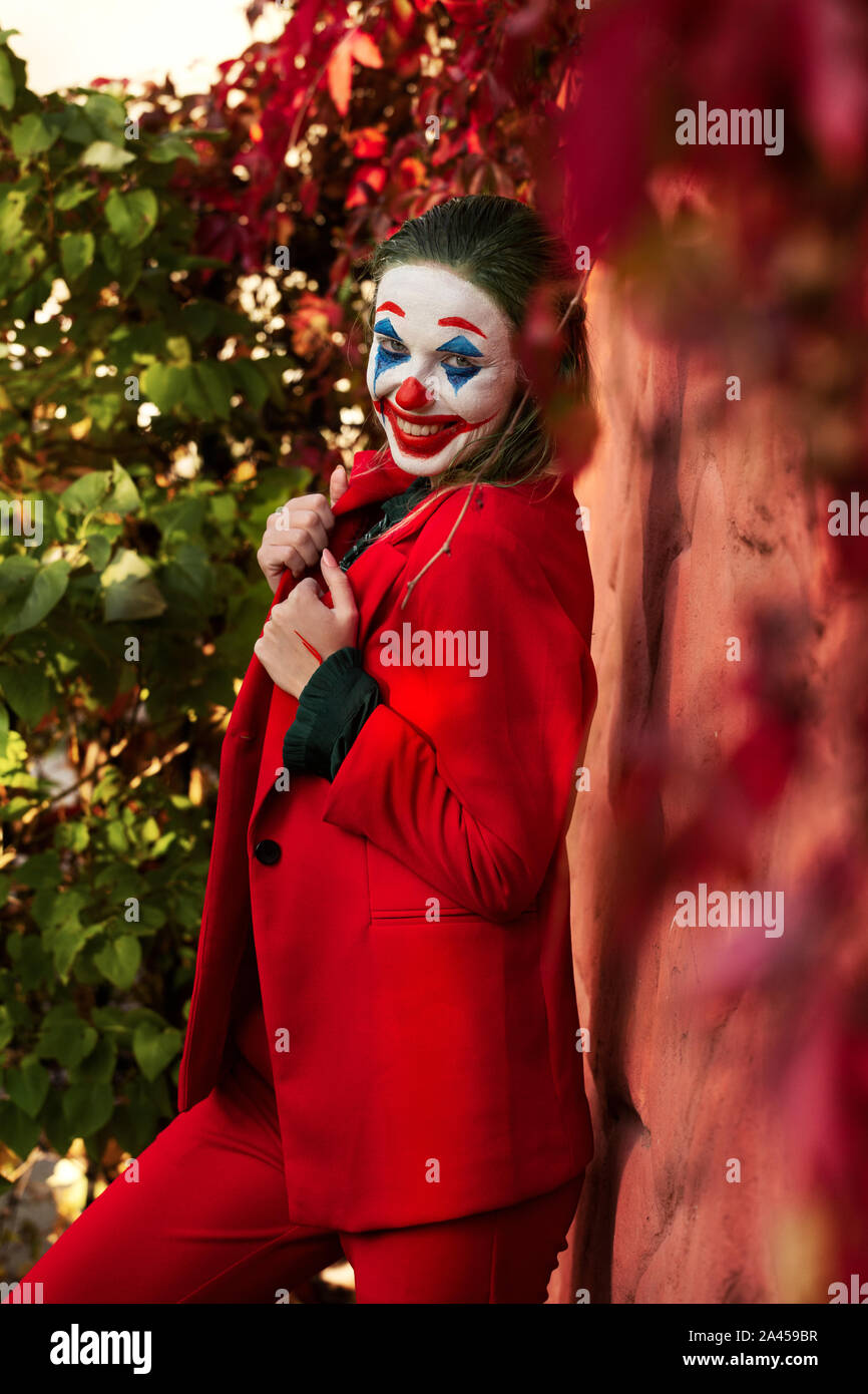 Young Woman With Joker Makeup And Costume Dancing Stock Photo Alamy