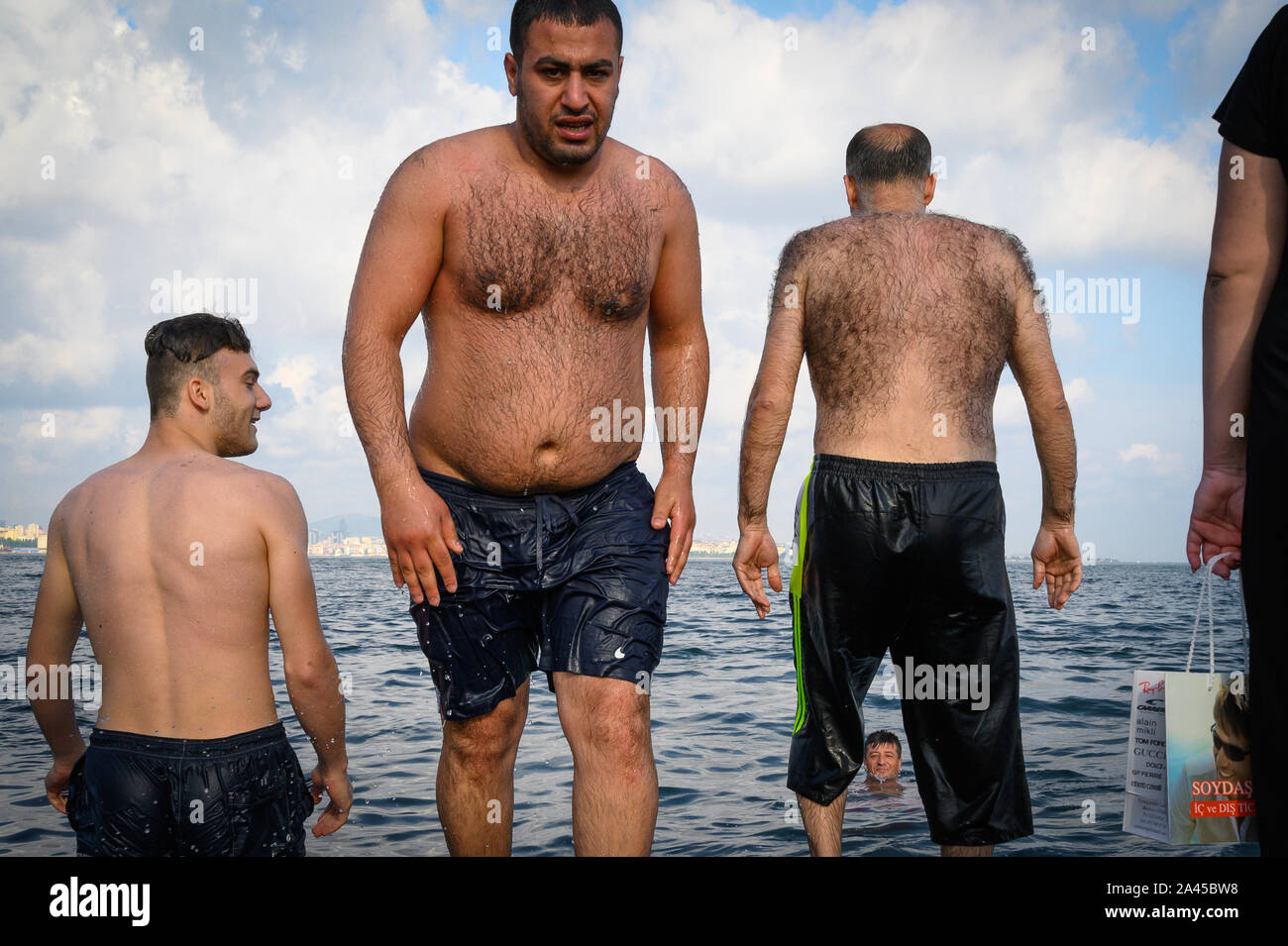 Hairy men on the shore of the Sea of Marmara, Istanbul, Turkey Stock Photo