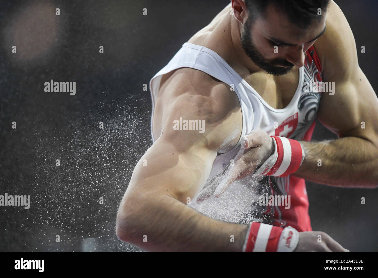 October 11, 2019, Stuttgart, Germany: OLIVER HEGI from Switzerland chalks up his arms before competing on the  pommel horse during the competition held in the Hanns-Martin-Schleyer-Halle in Stuttgart, Germany. (Credit Image: © Amy Sanderson/ZUMA Wire) Stock Photo