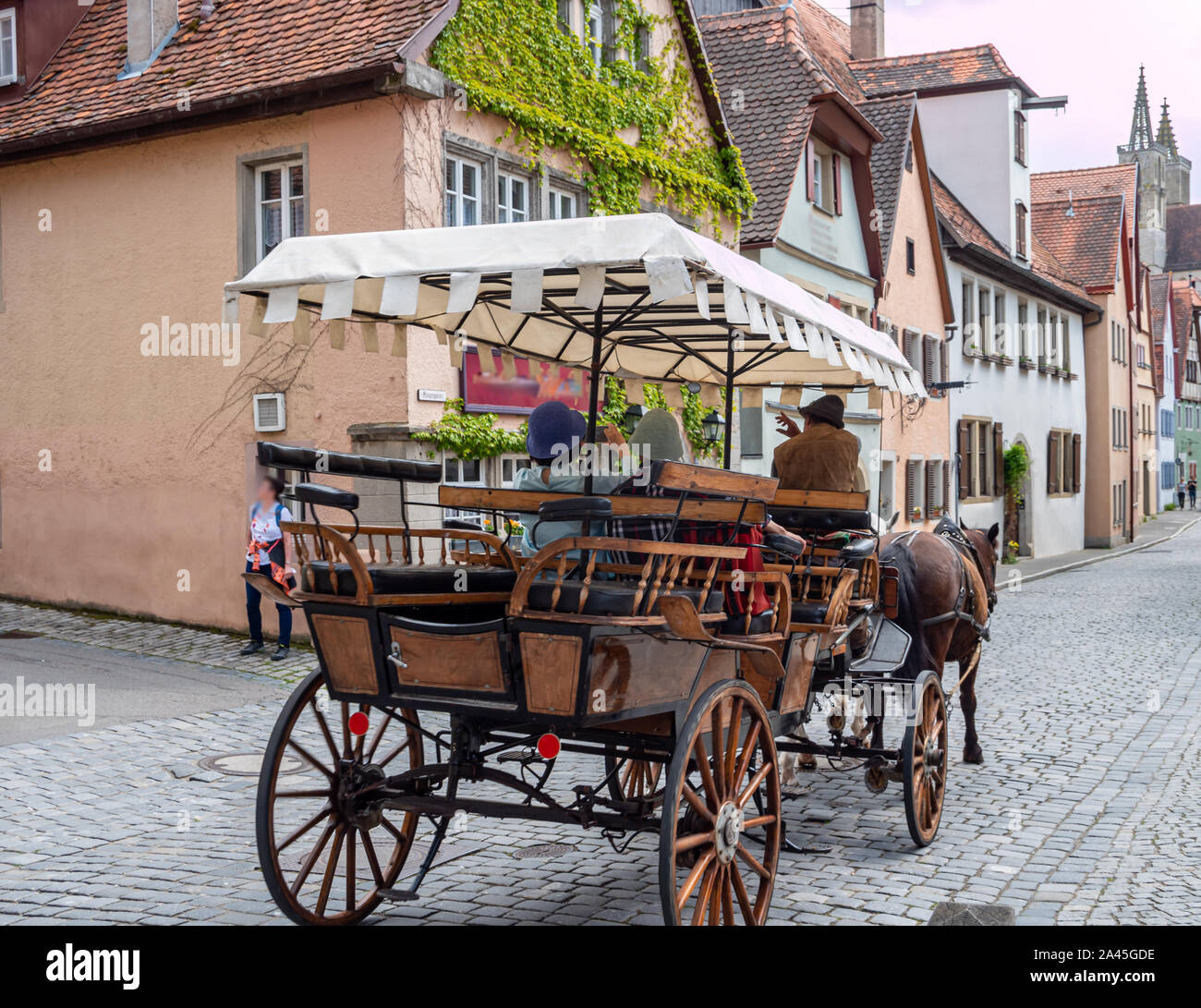 Horse-drawn carriage drives through the old town of Rothenburg ob der Tauber Stock Photo