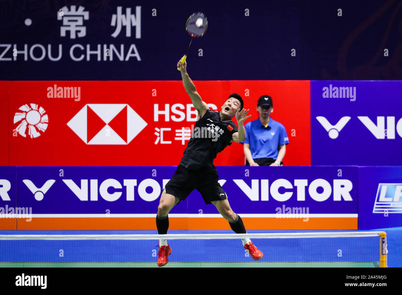 Chinese professional badminton player Chen Long competes against