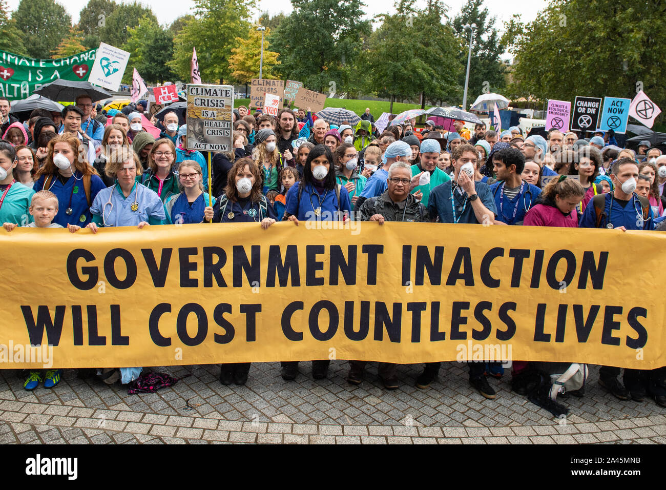Doctors gather to protest in support of Extinction Rebellion (XR) at Jubilee Gardens, London, to highlight deaths caused by air pollution. Stock Photo