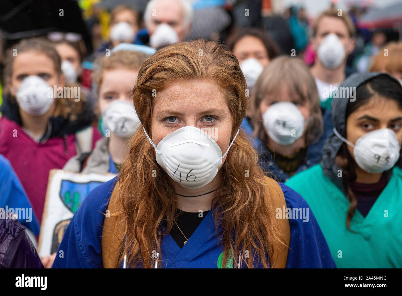 Doctors gather to protest in support of Extinction Rebellion (XR) at Jubilee Gardens, London, to highlight deaths caused by air pollution. Stock Photo