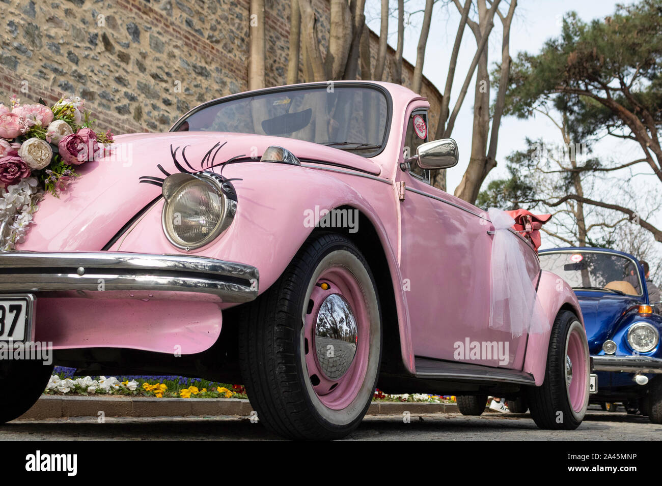 Pink classic car and sticky eyelashes in the headlight Stock Photo