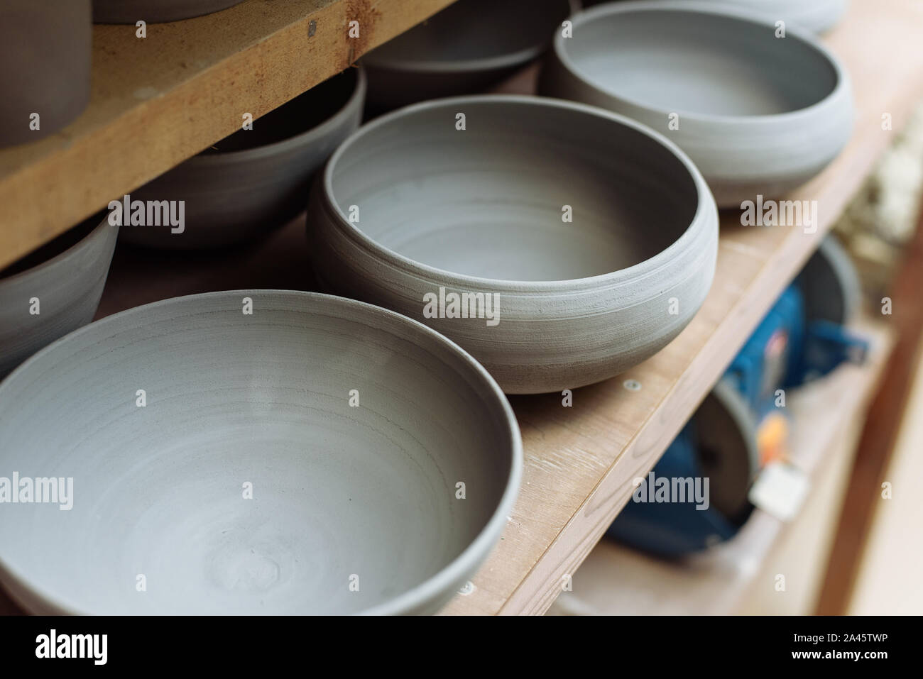 Gray handmade ceramic plates. Glazed clay plates in a pottery Stock Photo Alamy