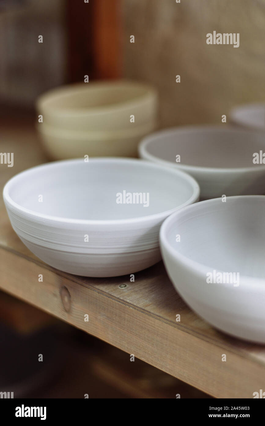 Gray handmade ceramic plates. Glazed clay plates in a pottery Stock Photo Alamy