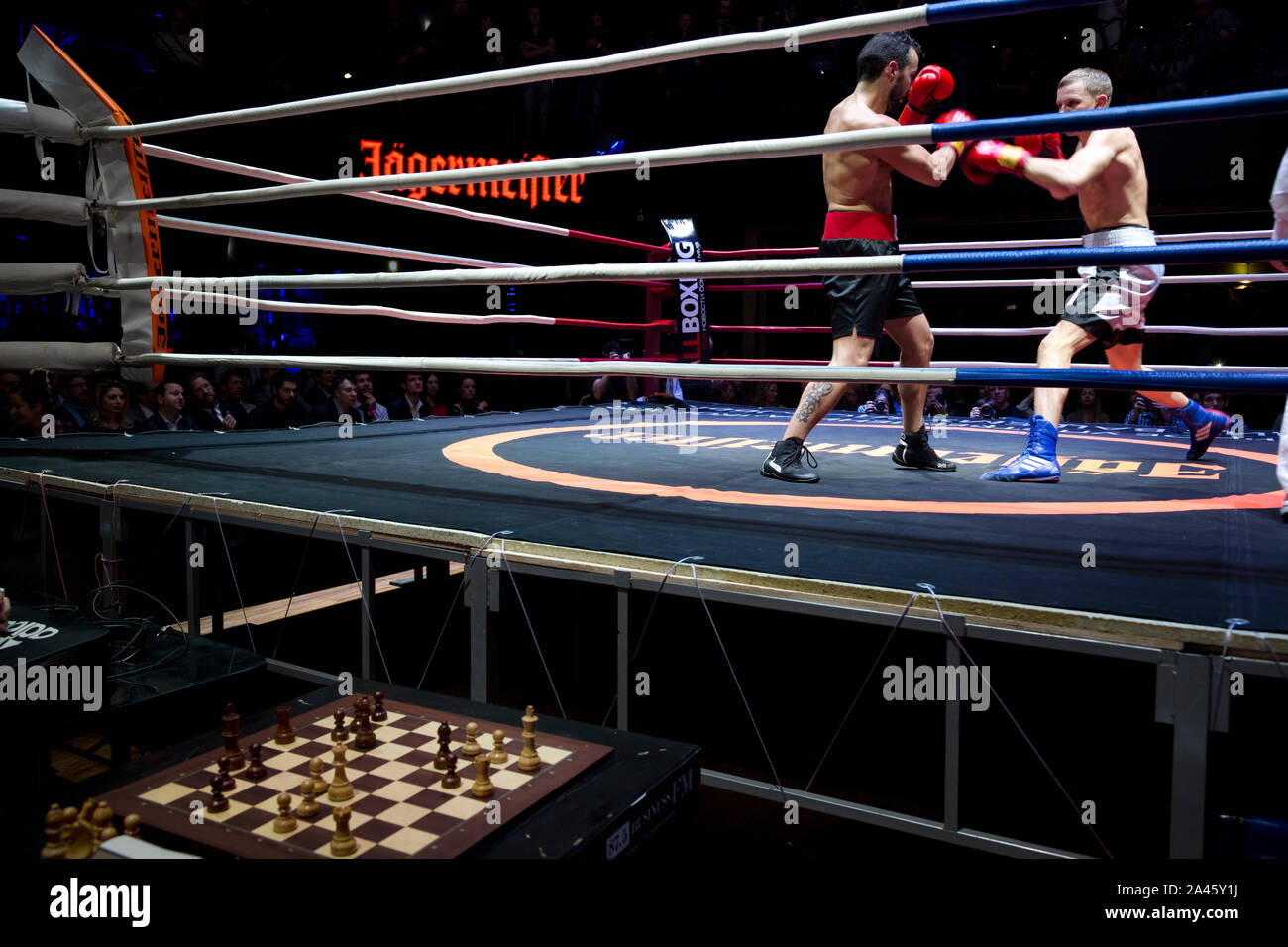 Chess boxers Arik Braun (R) and Felix Bartels sit in front of a chequer  board during the Chess Boxing Championships in Berlin, Germany, 28 July  2012. The chess boxing event took place