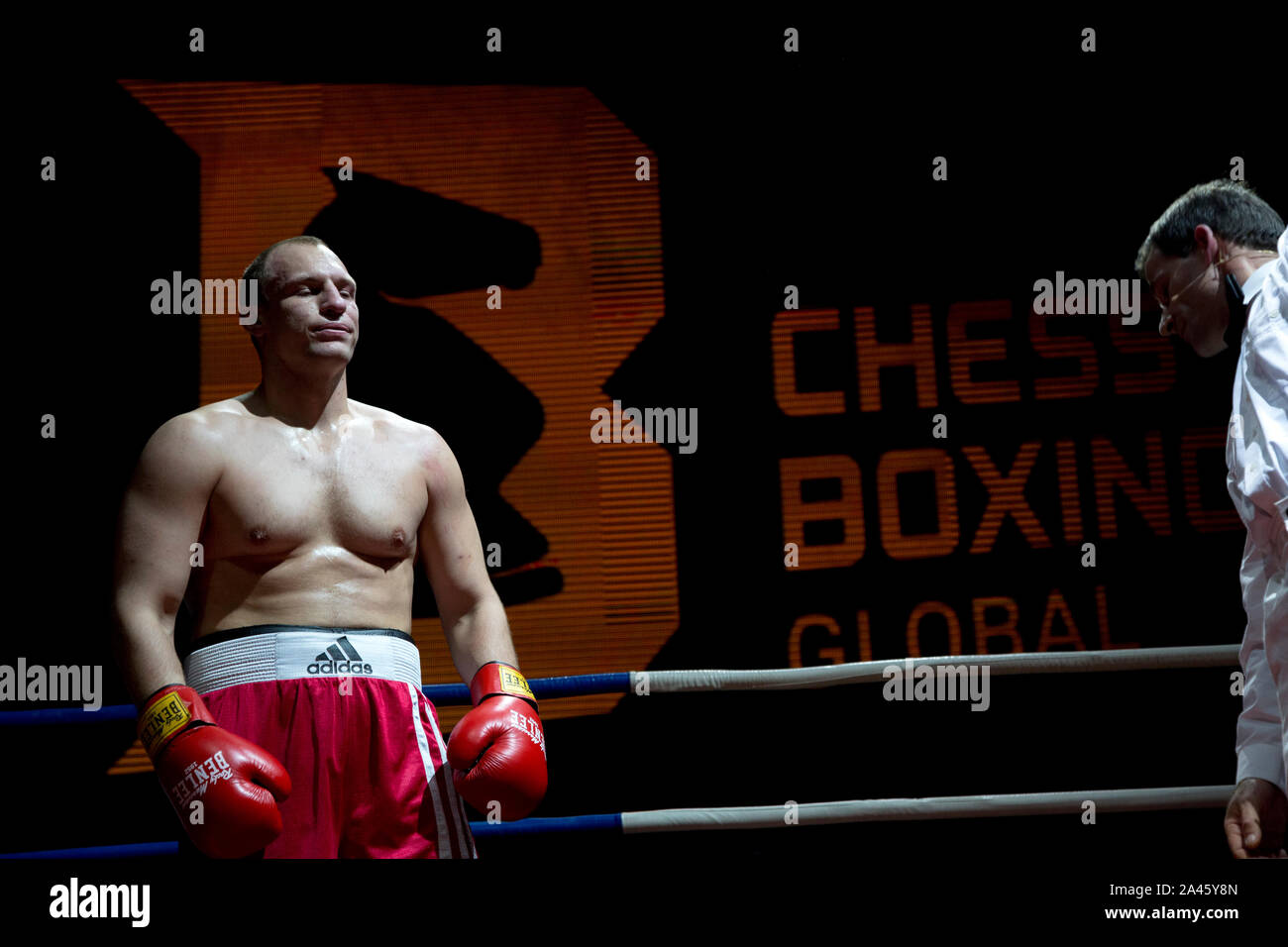 Moscow, Russia. 28th of November, 2013 Boxer Leonid Chernobaev from Belarus plays chess in the ring in the match of the World Chess Boxing Championship in Moscow, Russia Stock Photo