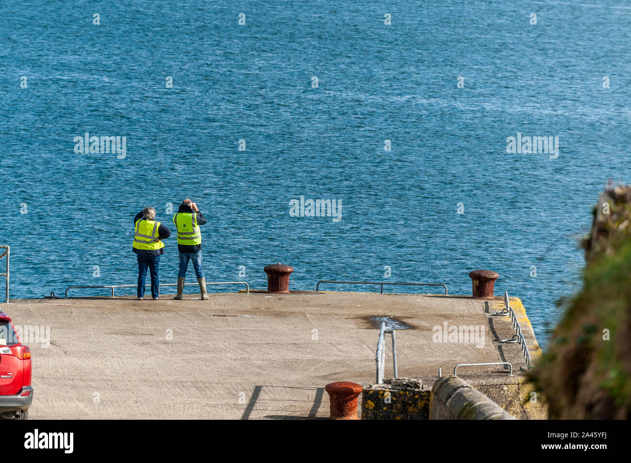 Dunmanus Bay, West Cork, Ireland. 11th Oct, 2019.  Two local volunteers scan the water for any sign of missing fisherman Kodie Healy.  Mr Healy went fishing on Wednesday morning but didn't return.  Credit: Andy Gibson/Alamy Live News Stock Photo