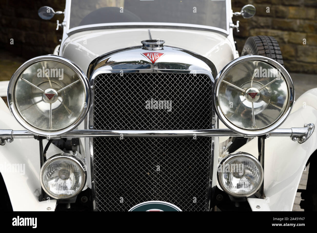 Front grill and headlights of a white mid 1930s Alvis Speed 20 classic car at Goathland railway station North Yorkshire England Stock Photo
