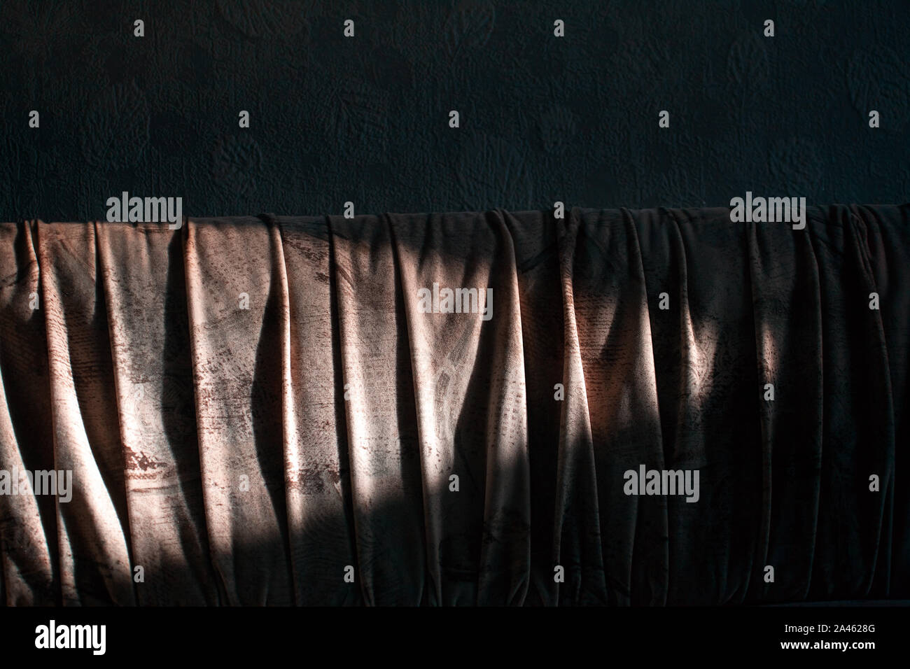 sunlight and shadow falls on a sofa Stock Photo
