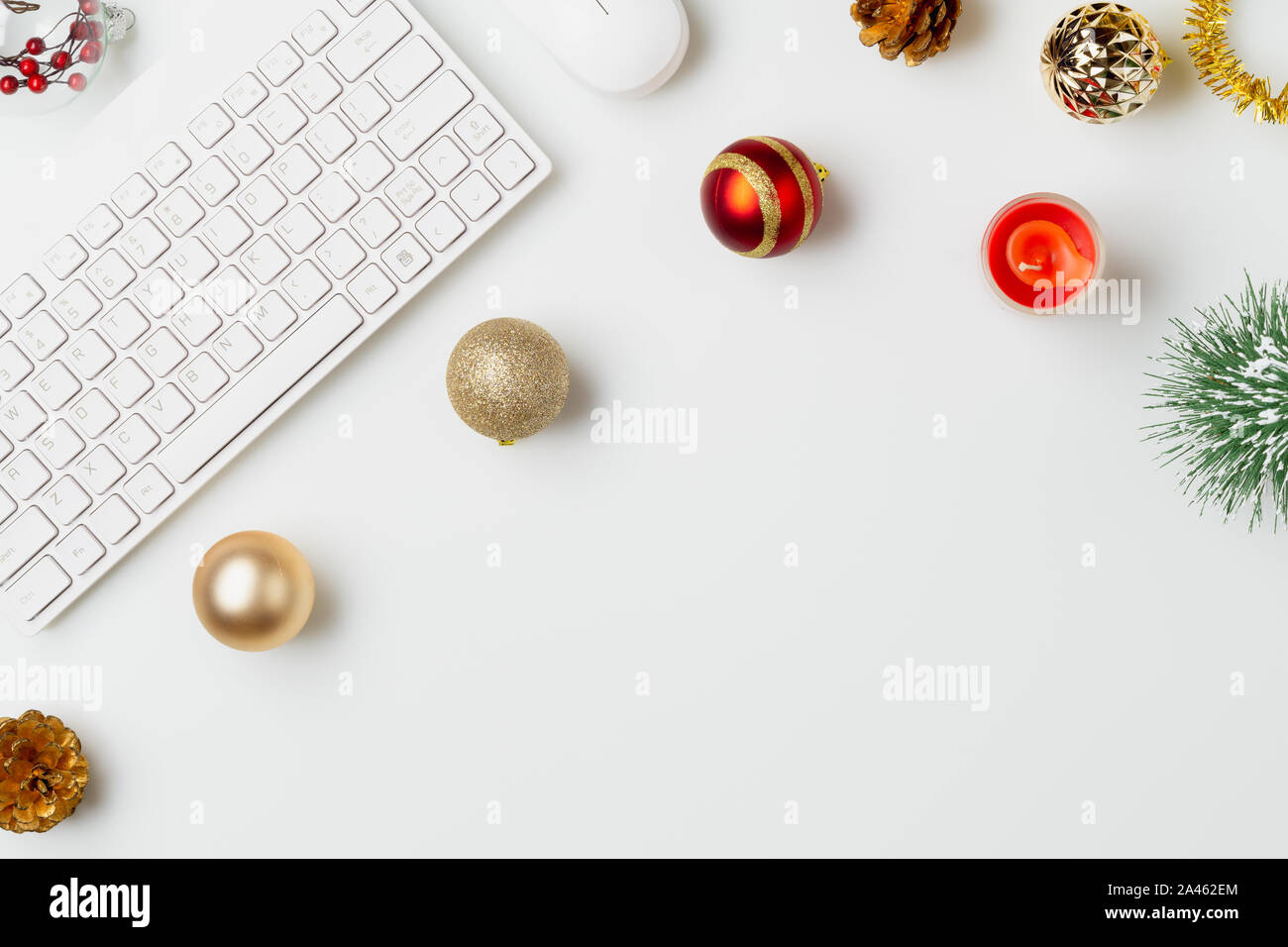 Flat lay top view office table desk, Christmas workspace with keyboard and christmas balls and other decorations on white background Stock Photo