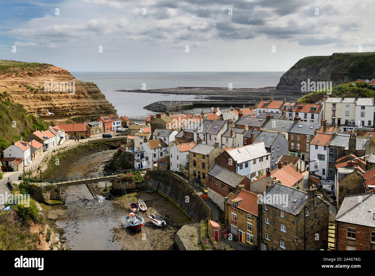 Overview of seaside village of Straithes where Straithes Beck empties into the  Harbour on the North Sea at low tide North Yorkshire England Stock Photo