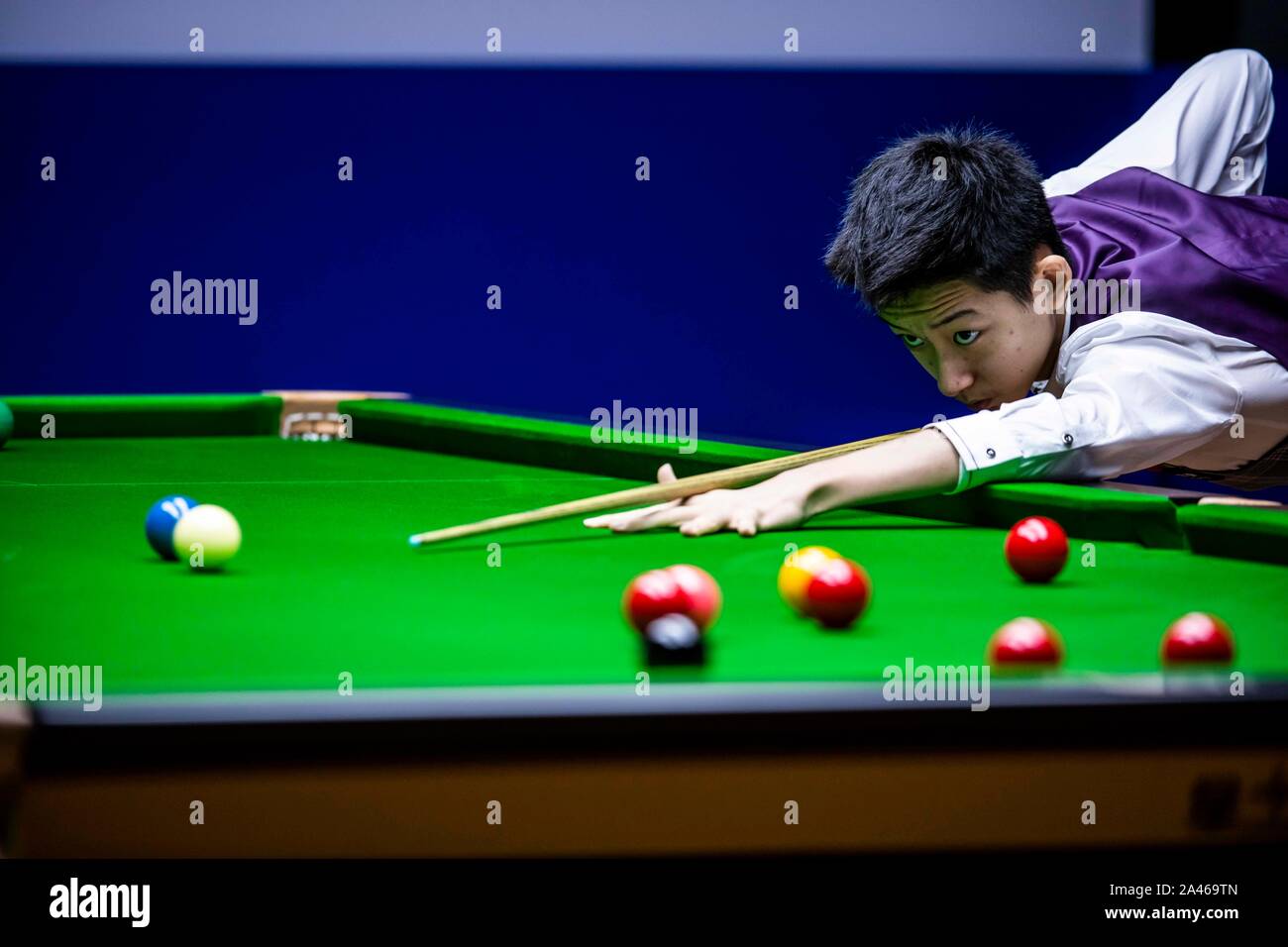 Chinese professional snooker player Wu Yize plays a shot at the Round 1 ...