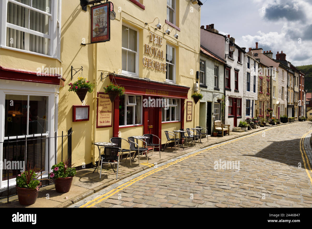 The Royal George hotel restaurant on cobblestone High Street in the seaside village of Staithes North Yorkshire England Stock Photo