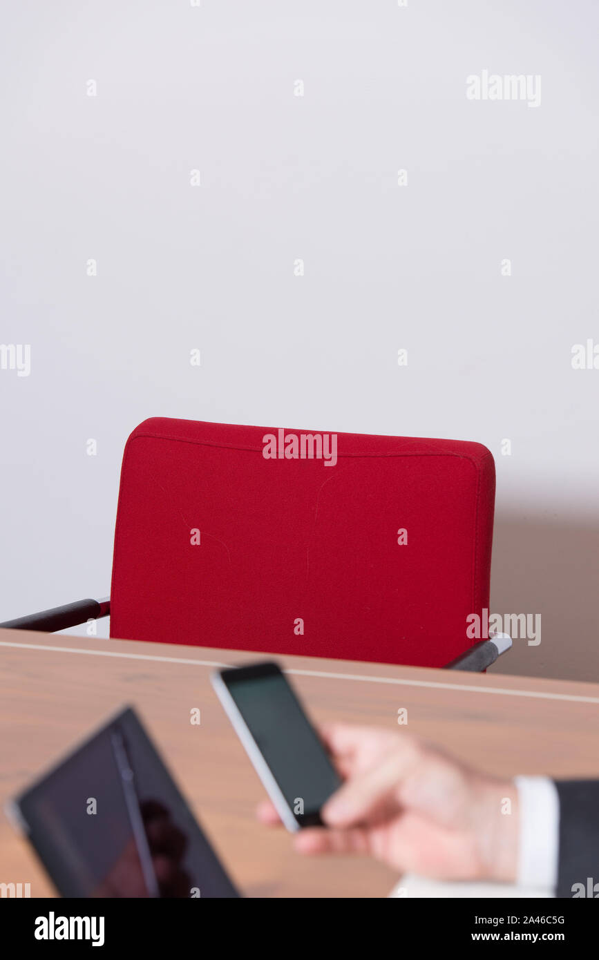 Empty red chair at a business meeting. Stock Photo