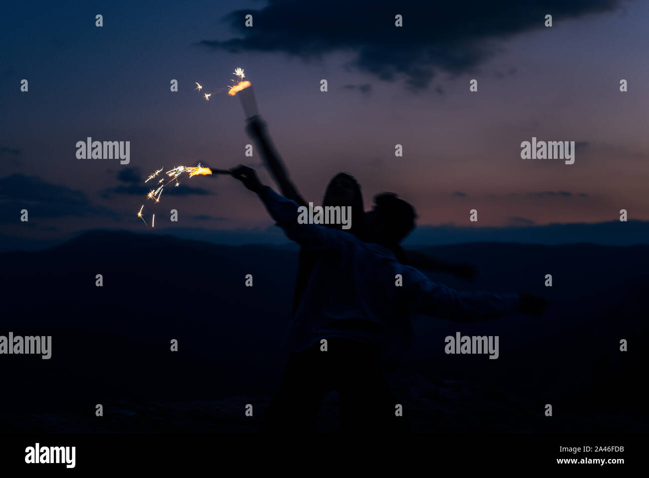 Two silhouette athletic young dancers making a performance at mountain Stock Photo