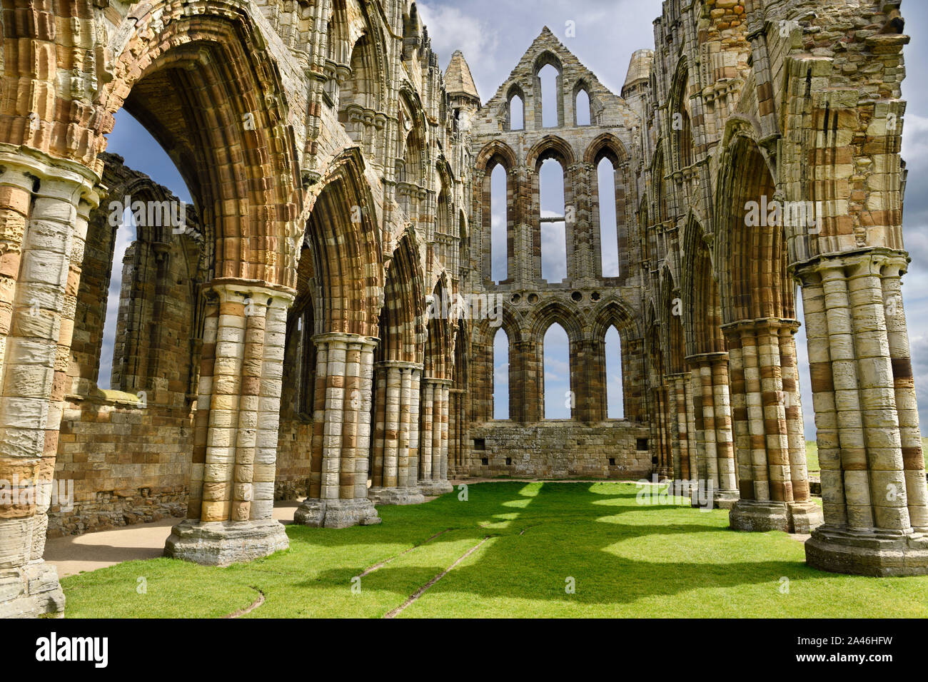 Chancel and wall of the Sanctuary of Gothic ruins of Whitby Abbey church in sunshine North York Moors National Park England Stock Photo