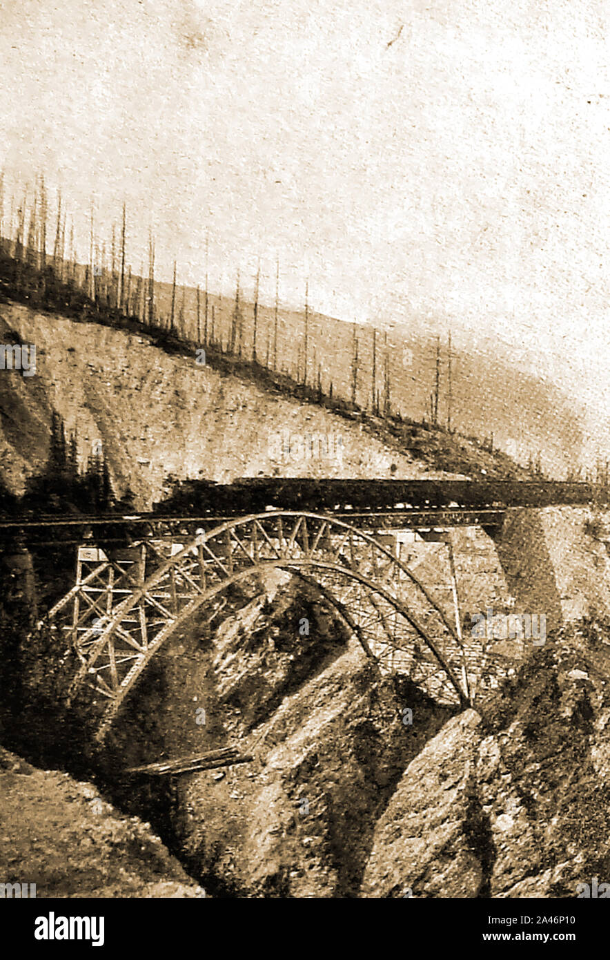 1900 photograph -  A goods train passing over Stoney Creek Bridge near Roger's Pass - (Canadian Pacific Railways). The  200-metre-long (656 ft) 'truss arch bridge' in British Columbia, Canada was built in 1893 and replaced a wooden one which at that time was the tallest wooden bridge in the world. It is  over 600 feet  long and stands 325 feet above the creek Stock Photo