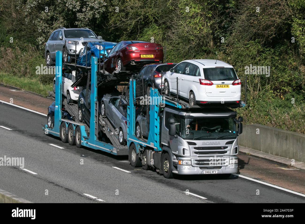 A Scania heavy goods vehicle hgv transporting second hand cars on trailer southbound on the M6 motorway near Preston in Lancashire, UK Stock Photo