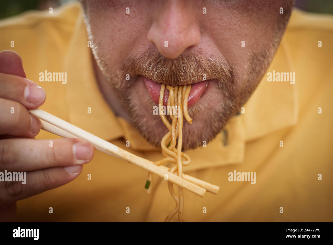 Thai food. Man eating noodles with chopsticks. food concept Stock Photo