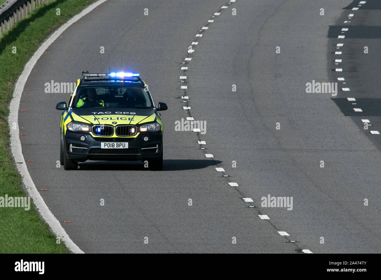 A police BMW X5 responding to an emergency on the M6 motorway near Preston in Lancashire, UK Stock Photo