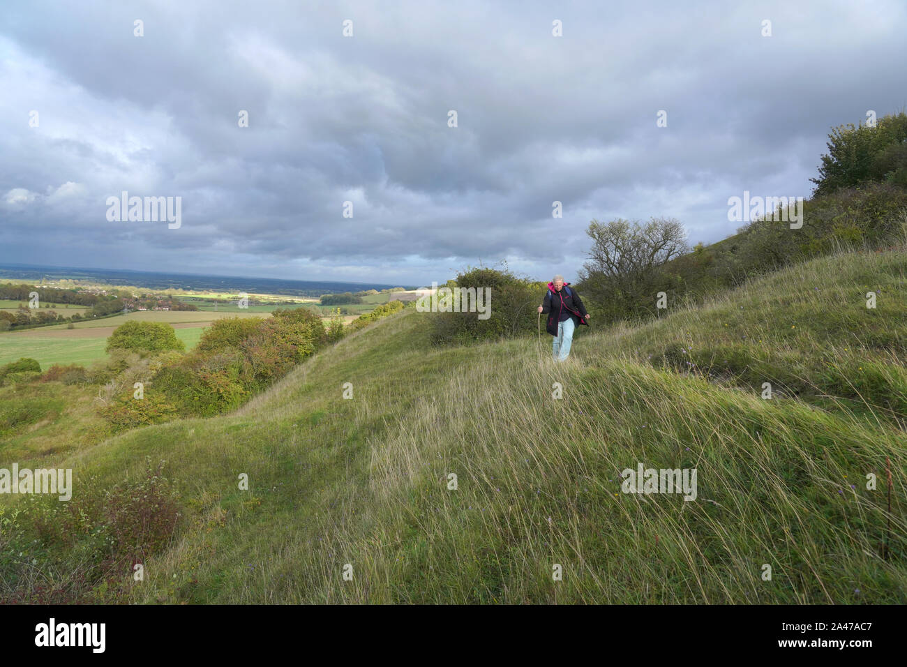 A woman walking in nature, Malling Down nature reserve near Lewes, East Sussex, England Stock Photo