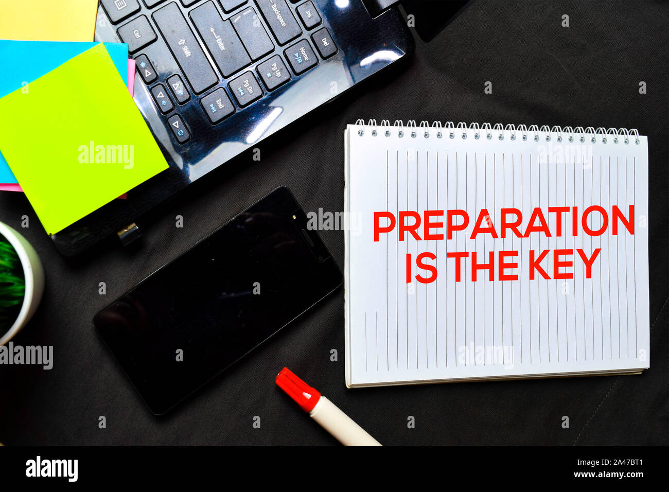 Preparation Is The Key text on a book at office desk. Isolated on black bakground Stock Photo