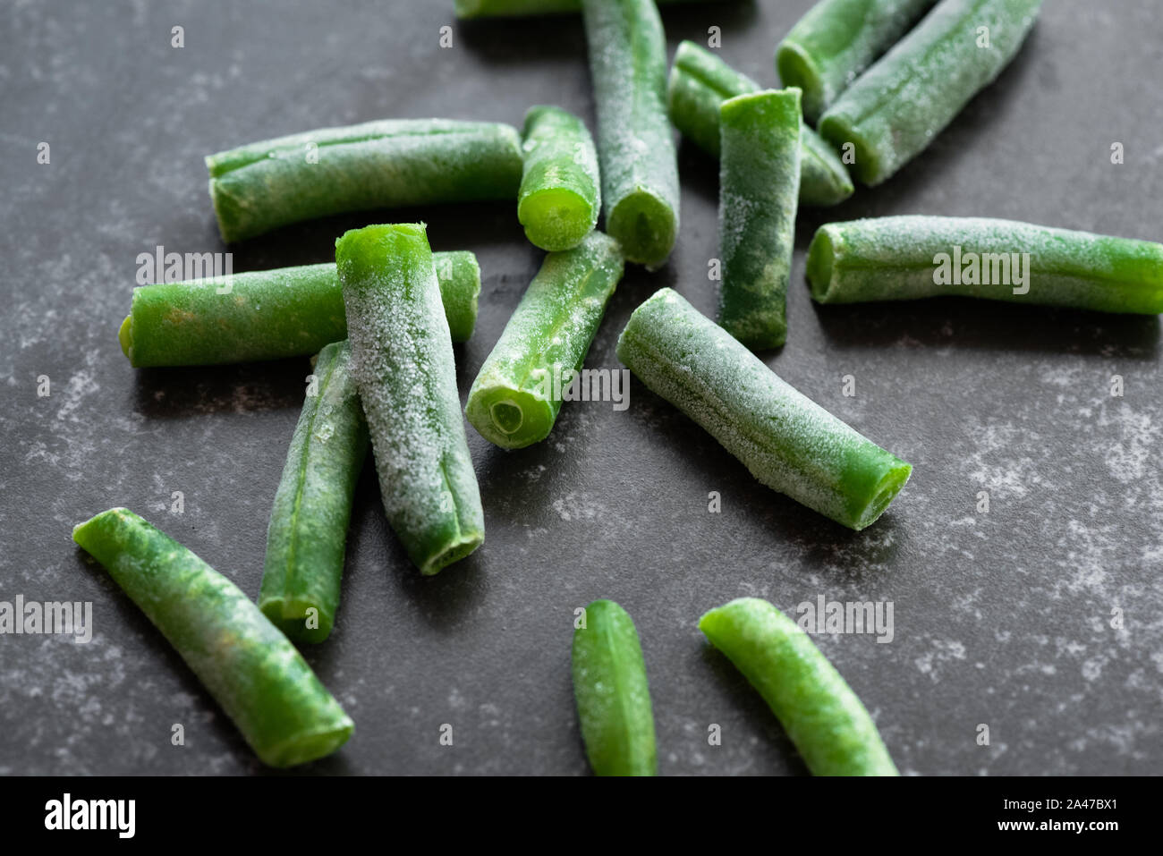 Green beans on a stone cutting board background. Stock Photo