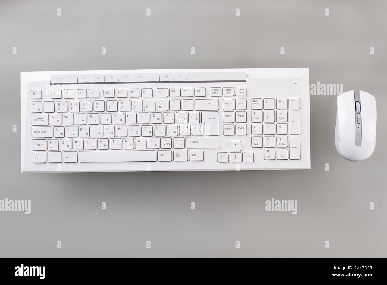 White keyboard and optical mouse on table. Stock Photo