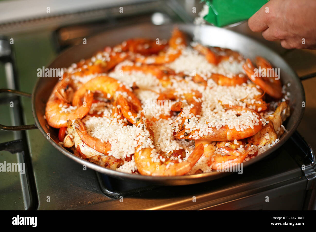 cooking paella in a steel pan Stock Photo Alamy