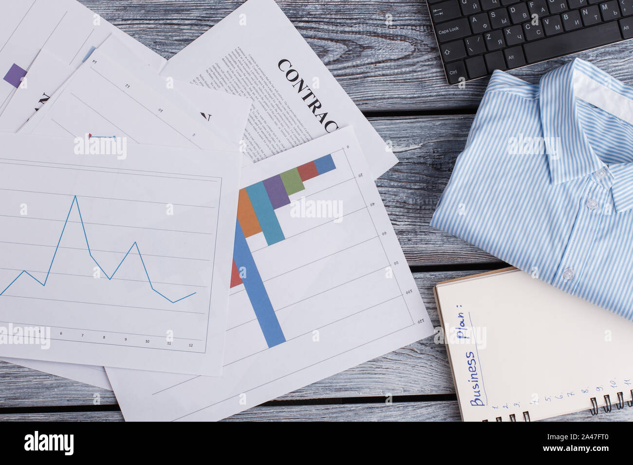 Papers and office items on wooden background. Stock Photo