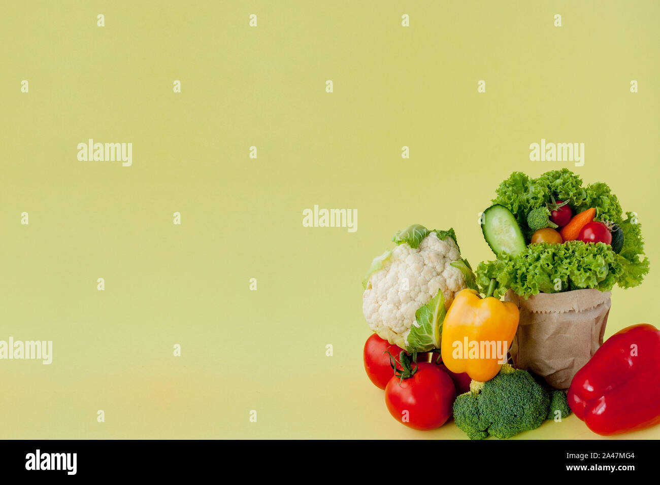 Organic vegetables broccoli cucumbers bell peppers apples in brown