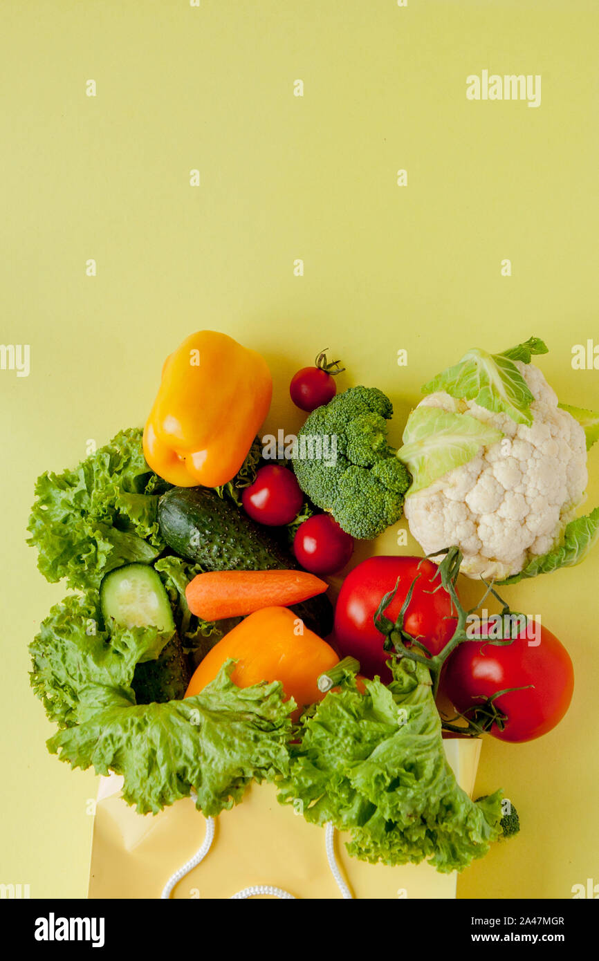 Organic vegetables broccoli cucumbers bell peppers apples in brown