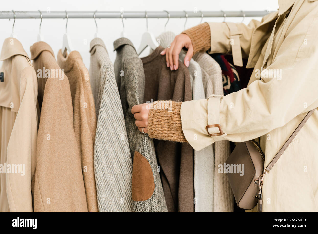 Contemporary young woman choosing casualwear in boutique Stock Photo