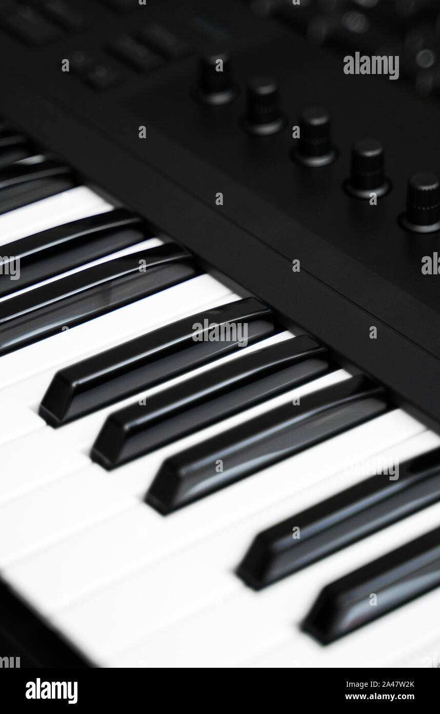 Professional midi keyboard synthesizer with knobs and controllers. Stock Photo