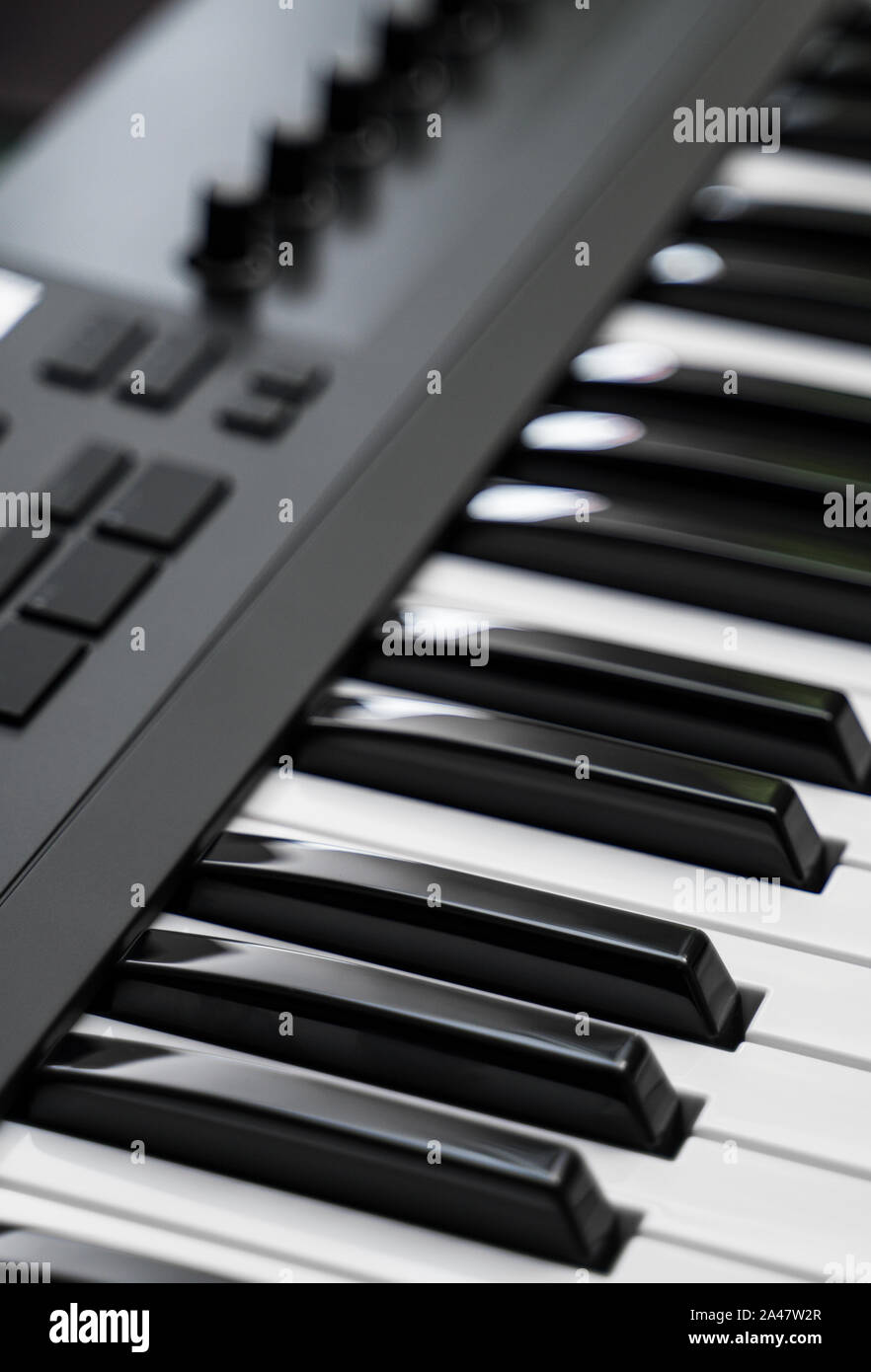 Professional midi keyboard synthesizer with knobs and controllers. Stock Photo