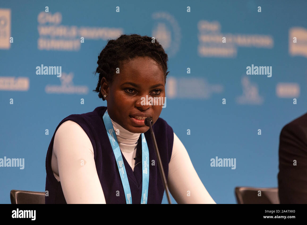 COPENHAGEN, DENMARK – OCTOBER 11, 2019: Hilda Flavia Nakabuye, climate activists within the ‘Fridays for Future’ movement, Uganda, during the ‘Mayors and Youth Activist’ press conference at the C40 World Mayors Summit  The young activist from Uganda gave a powerful and emotional speech and broke into tears. Her speech caused great appluas from the tightly packed press room. During the press conference young activist explained what they expect of the grown-up politicians. More than 90 mayors of some of the world’s largest and most influential cities representing some 700 million people meet in Stock Photo