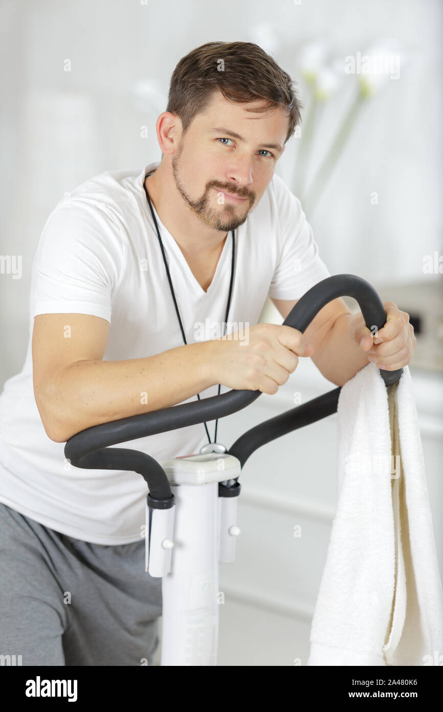 Young man on step machine hi-res stock photography and images - Alamy