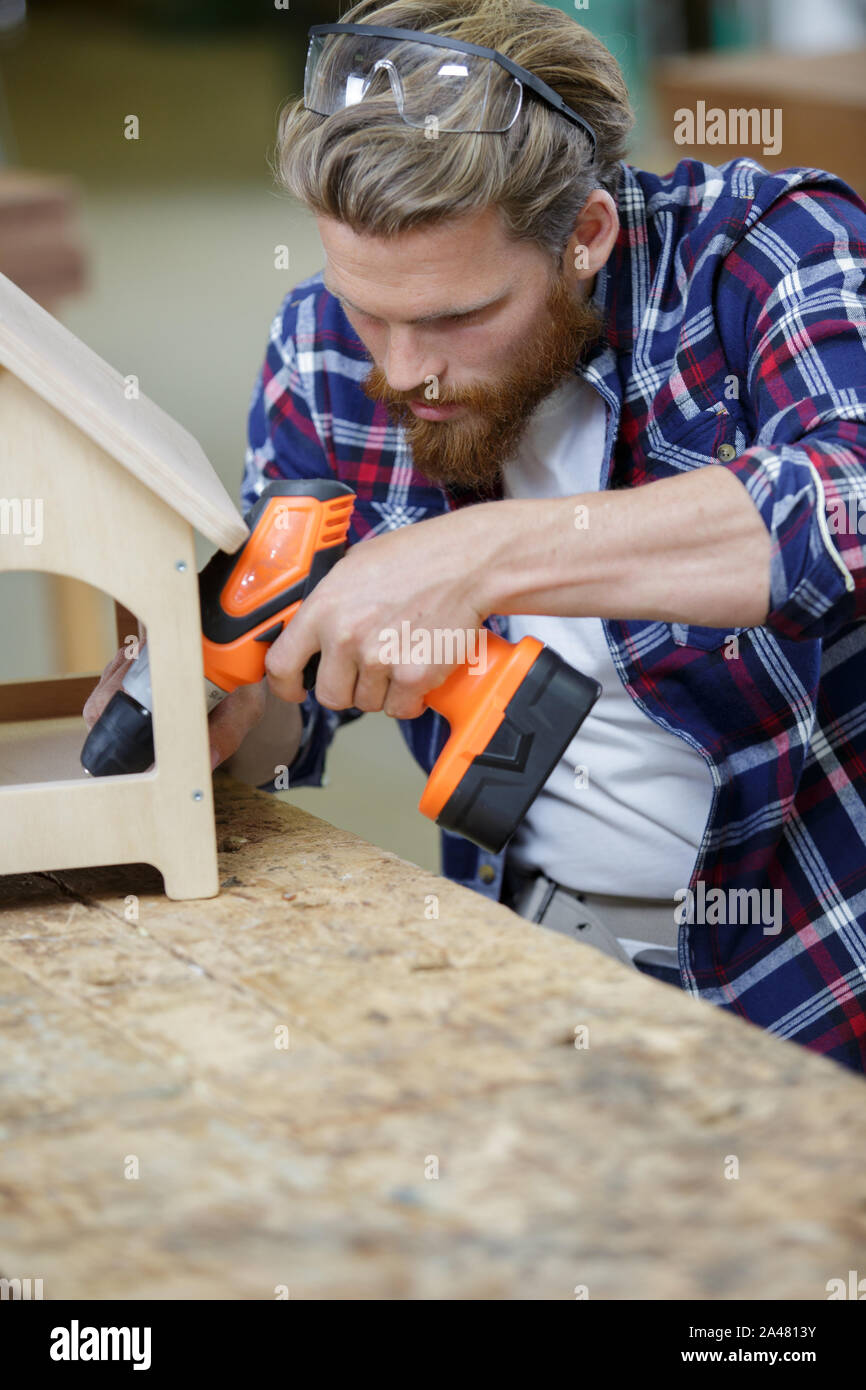 a man drilling a new house Stock Photo Alamy