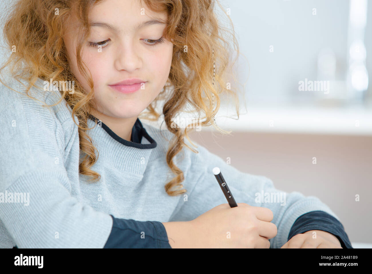 young girl and a pen Stock Photo - Alamy