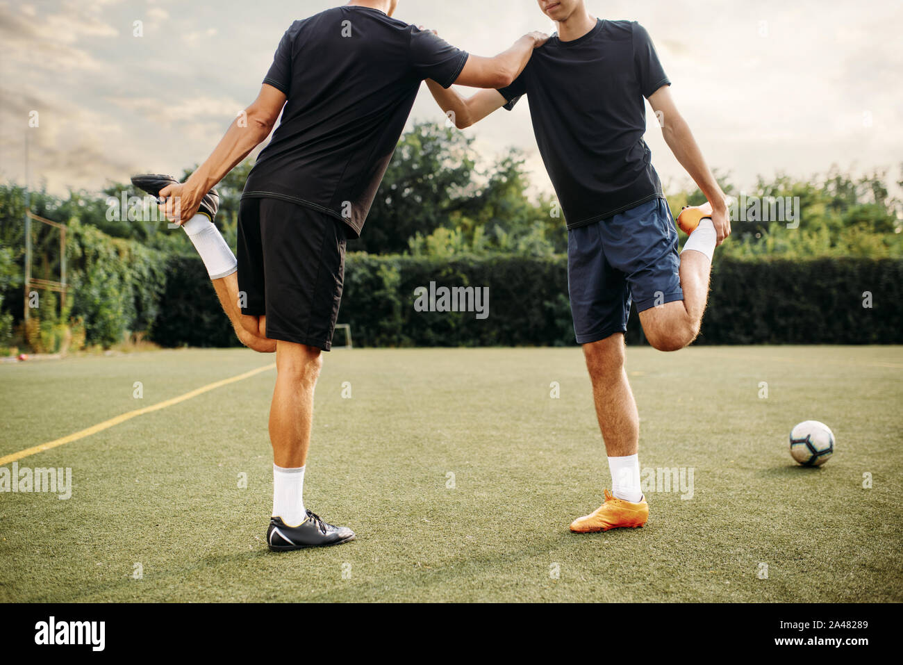 Two soccer players doing stretching exercise Stock Photo Alamy