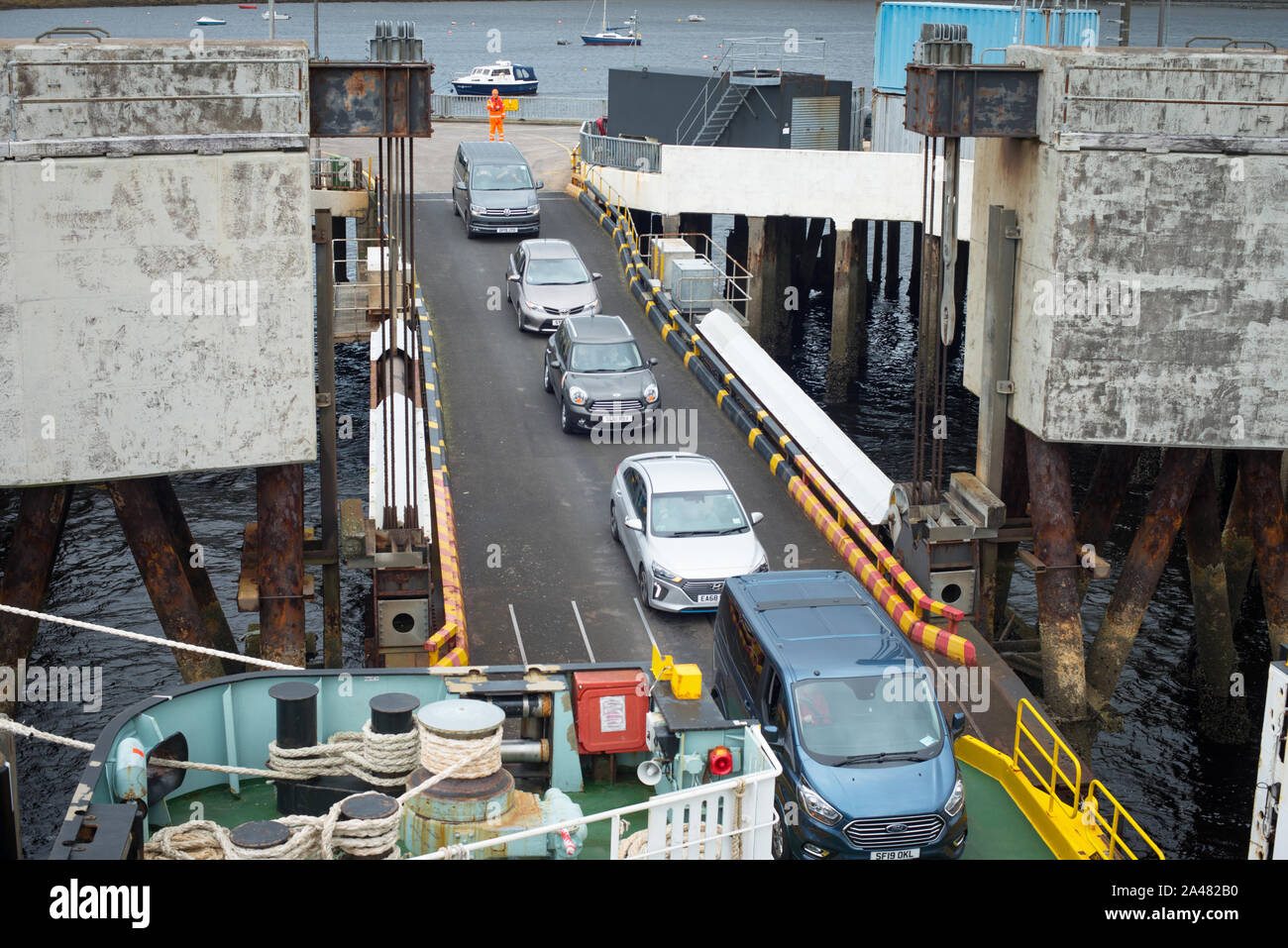 Cars waiting to board a car ferry in Uig, Isle of Sky bound  for Harris, Outer Hebrides. Scotland UK. Uig to Tarbert route run by Calmac Ferries. Stock Photo