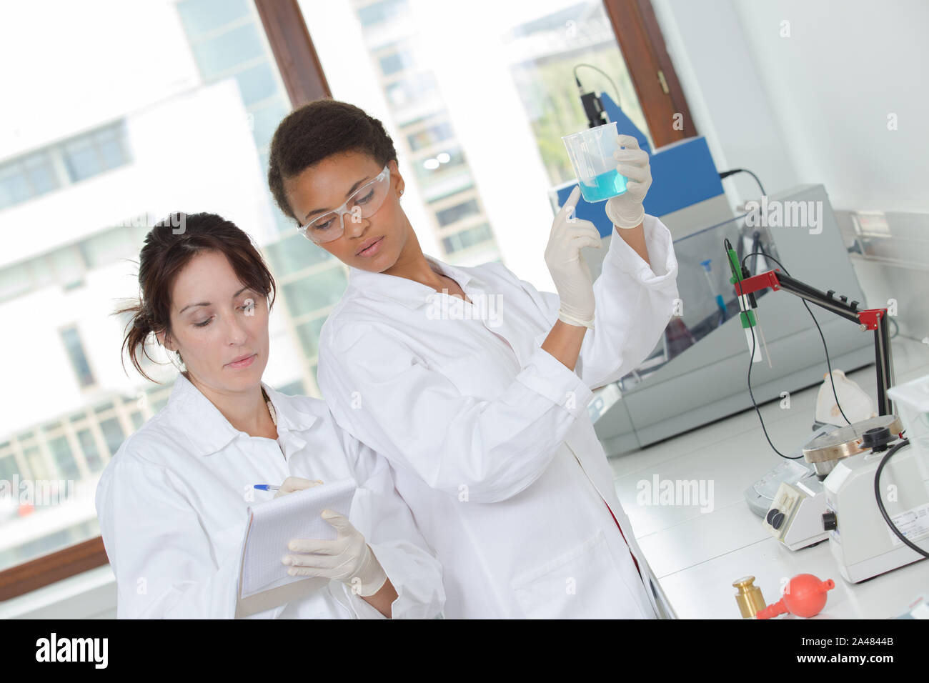 two young female scientist doing experiments in lab Stock Photo - Alamy