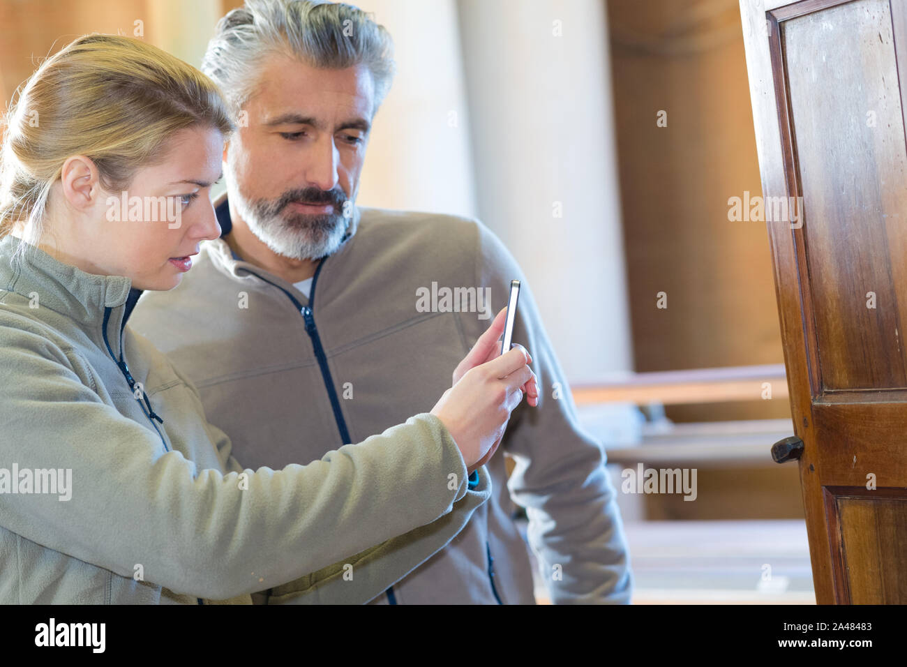 worker in a handmade furnitures store taking a picture Stock Photo Alamy