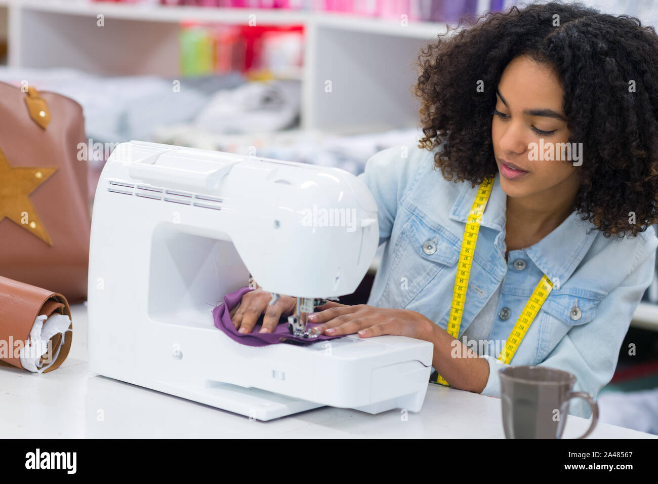 beautiful smiling tailor enjoying work on sewing machine Stock Photo ...