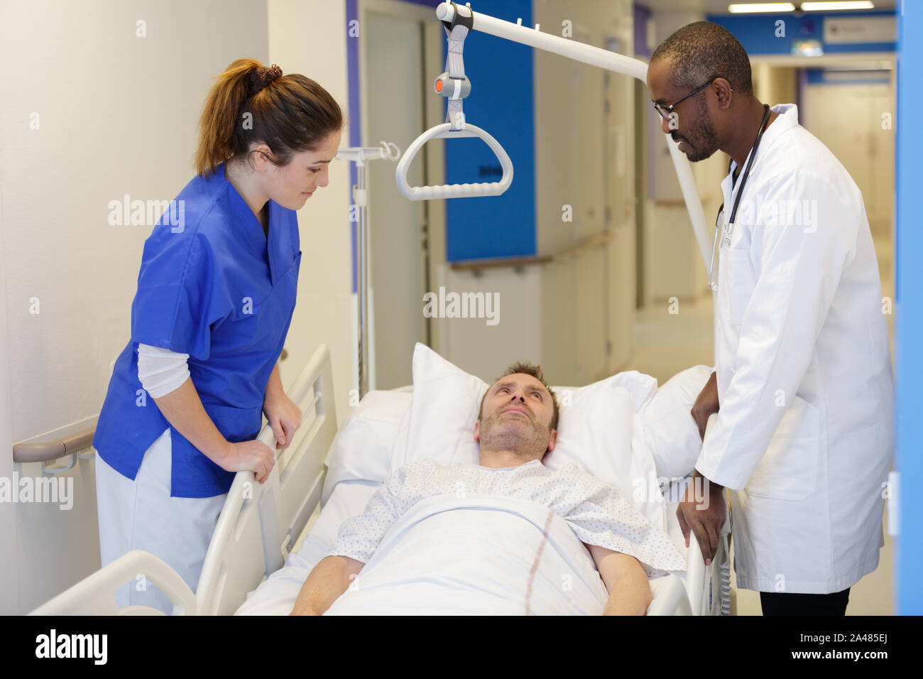 medical team attending female patient on hospital bed Stock Photo Alamy
