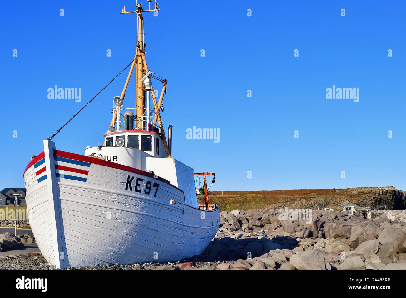 Reykjanesbaer, Iceland. A former fishing boat perched on a rock formation as a statue or monument at Reykjanesbaer. Stock Photo