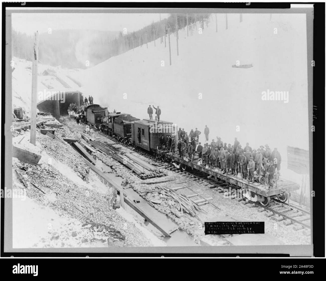 First train going through the C.M. & St. P. Pass, Bitter Root Mountains, Idaho Stock Photo