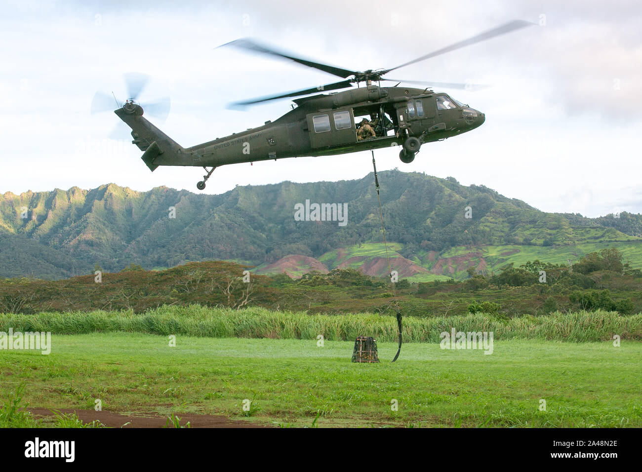 U.S. Army UH-60 Black Hawk helicopter assigned to 2nd Battalion, 25th Aviation Regiment sling loads 155mm rounds before a live-fire air assault artillery raid on Schofield Barracks, Hawaii, October 10, 2019. The 25th Combat Aviation Brigade worked alongside Charlie Battery, 2nd Battalion, 11th Field Artillery Regiment on the first live-fire air assault of M777 Howitzers ever conducted on the island of Oahu. (U.S. Army photo by 1st Lt. Ryan DeBooy) Stock Photo